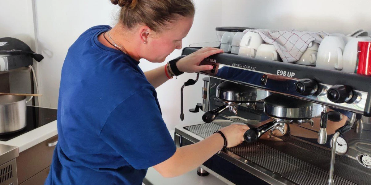 Sumero Savez beneficiary Nejra H. prepares coffee in the 