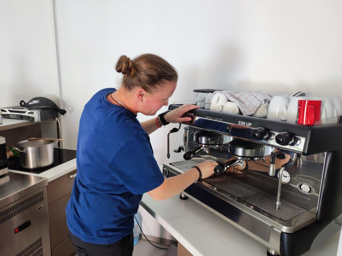 Sumero Savez beneficiary Nejra H. prepares coffee in the